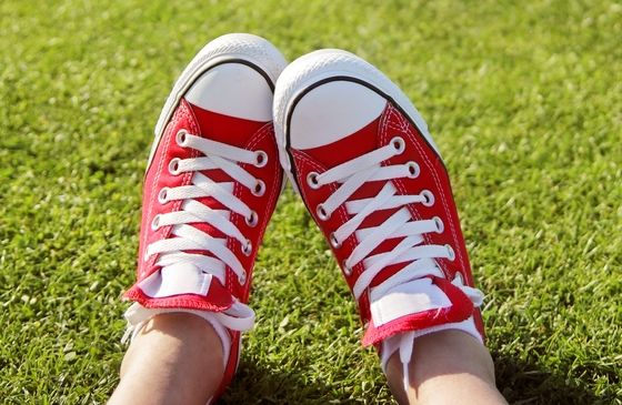 Close-up of feet in a pair of red sneakers