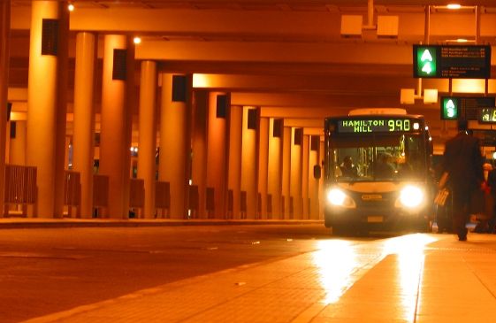 Bus arriving at the station in the middle of the night.