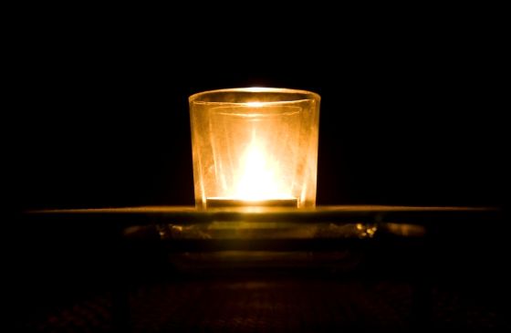 a single, lit votive candle