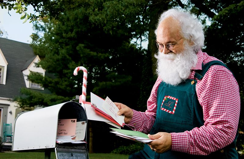 Cliff Snider collects letters from children from his mailbox.
