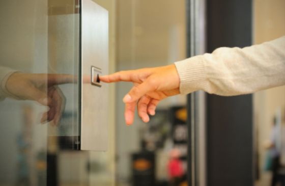 woman pushing elevator button.