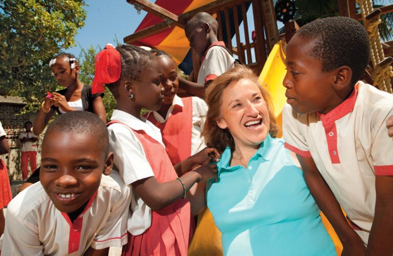 Michelle poses with some of the children she got to know in Haiti.