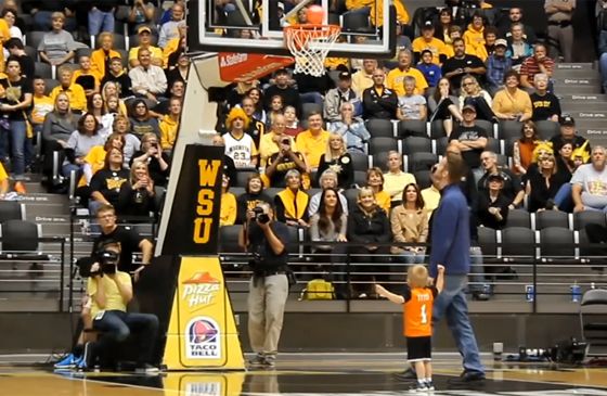 Titus sinks a bucket during halftime of a college basketball game.