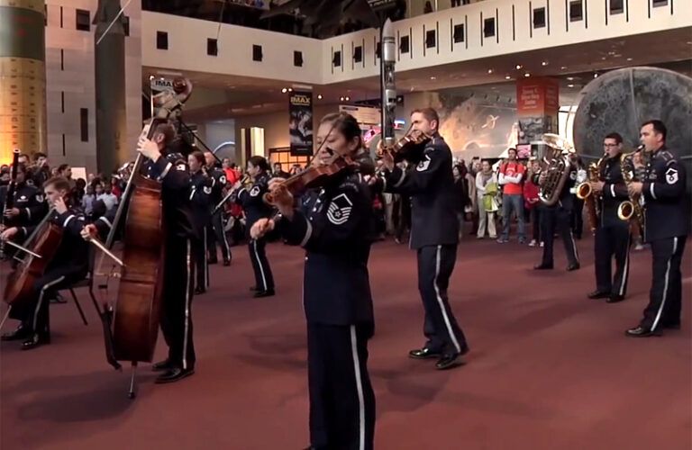 A flash mob composed of military musicians performs.