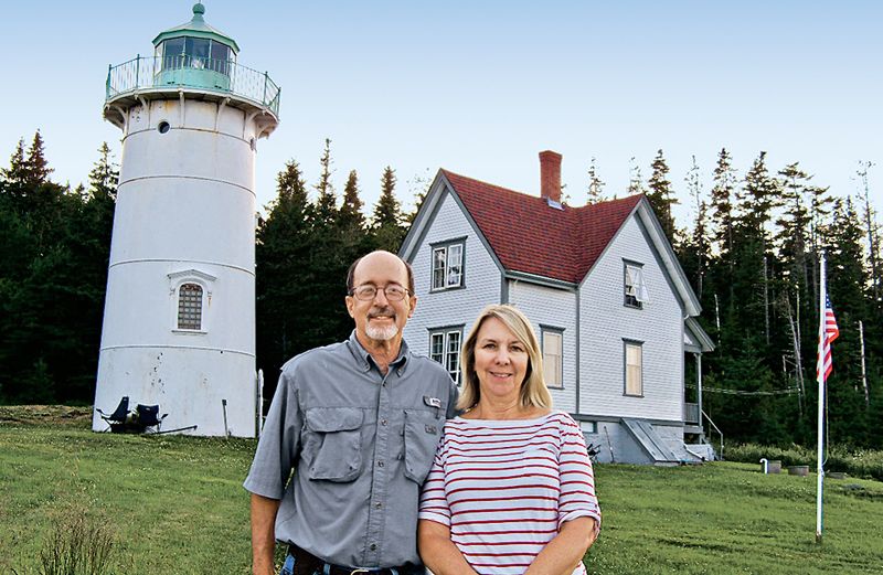 Chuck Turk and his wife, Marilyn, pose in front of the Little River Lighthouse.