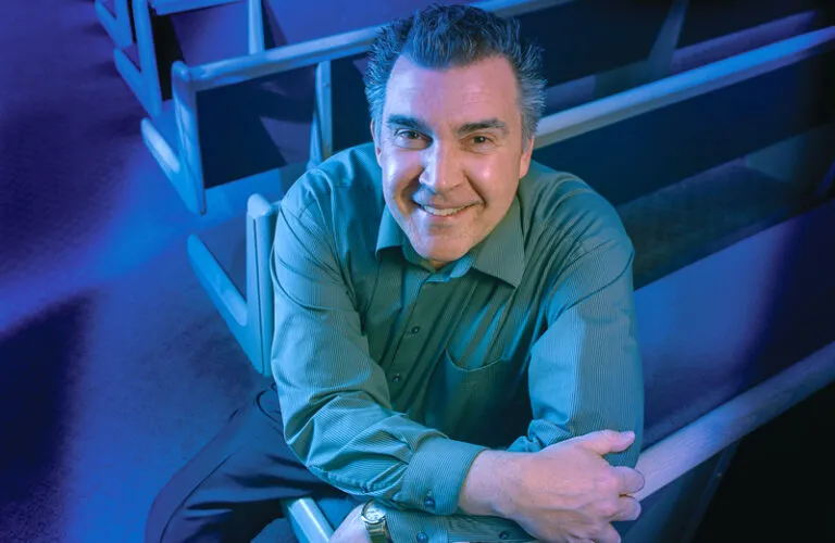 Dave Hess sits in a pew at his church.