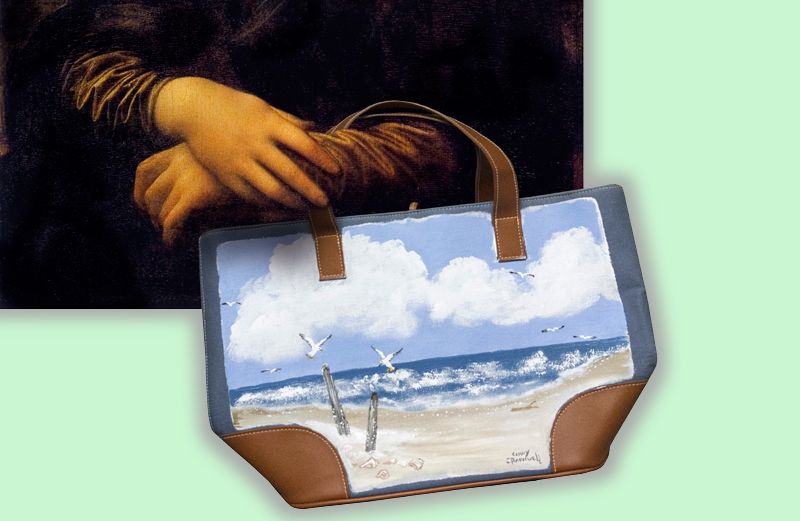 Mona Lisa's hands holding one of Cindy's painted tote bags