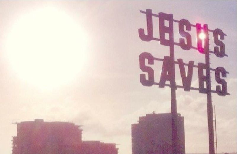 Jesus Saves sign over buildings in Los Angeles