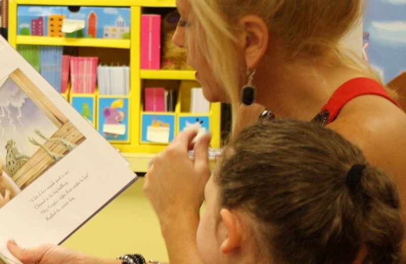 Inspirational Stories blogger Michelle Medlock Adams reading to a child