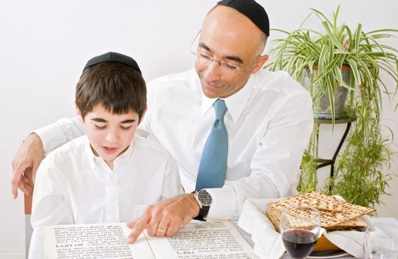 father and son celebrating Passover reading