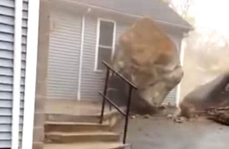 A huge boulder comes to a stop just inches before crushing a church.