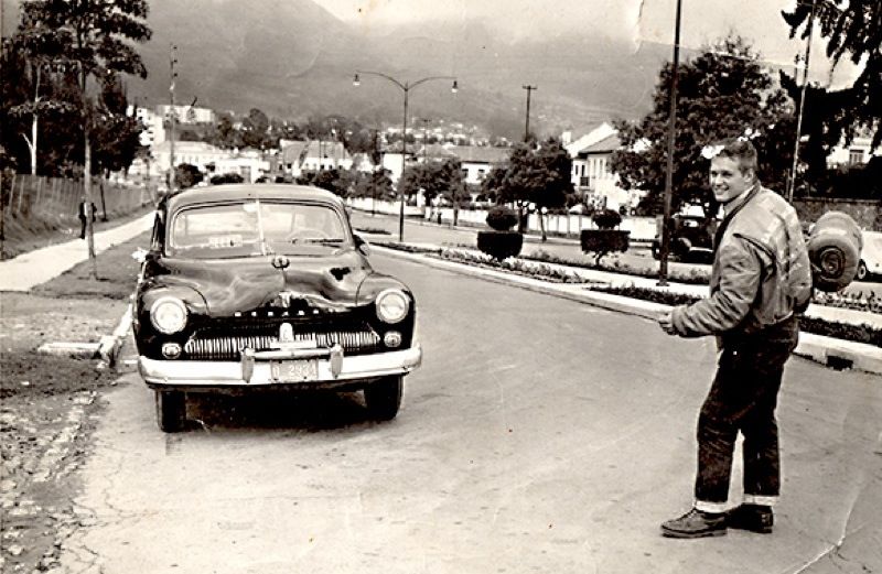 A young man next to a taxi in Ecuador, 1961. Photo courtesy Found magazine.