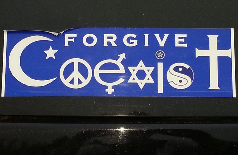 A blue and white bumper sticker that says FORGIVE COEXIST