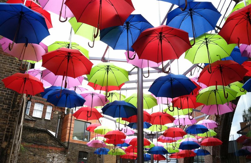 A lunch-break miracle: brightly colored umbrellas suspended in the air in London
