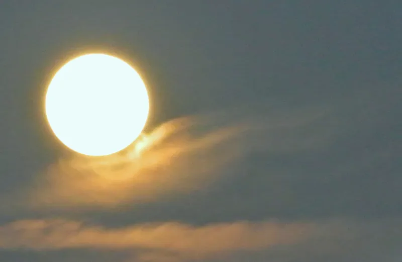 A beautiful full moon over wispy clouds