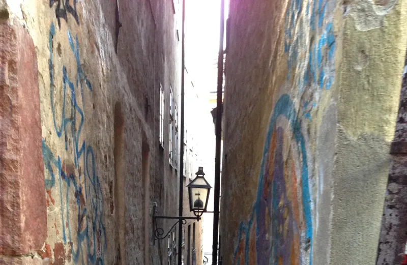 A narrow Stockholm alleyway lit up during an early-summer evening