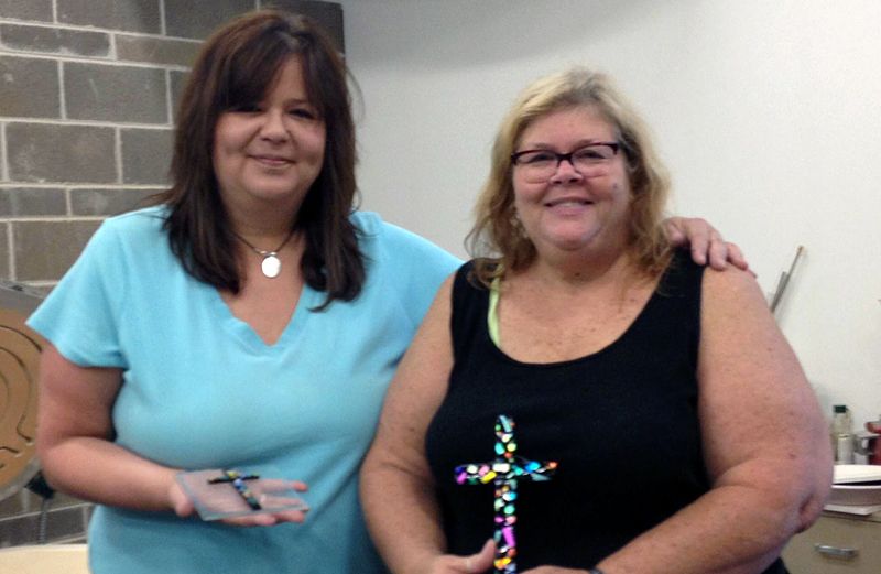 Blogger Daniel Kessel's mom holding the brightly colored glass cross.