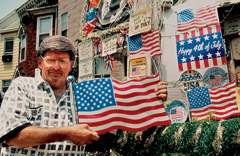 John Zammit poses in front of his house on Fourth of July.