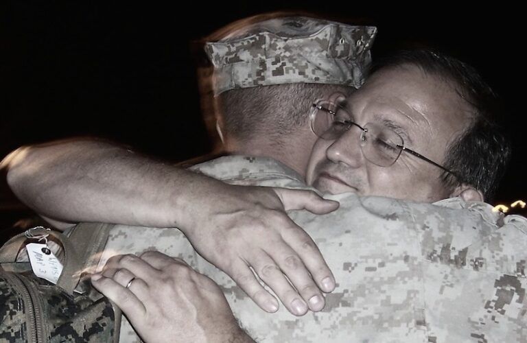 Edie's son Kirk, off for his first Iraq deployment, gets a hug from his dad.