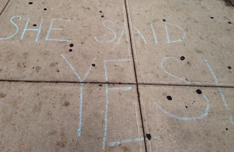 Message of love written in chalk on a sidewalk