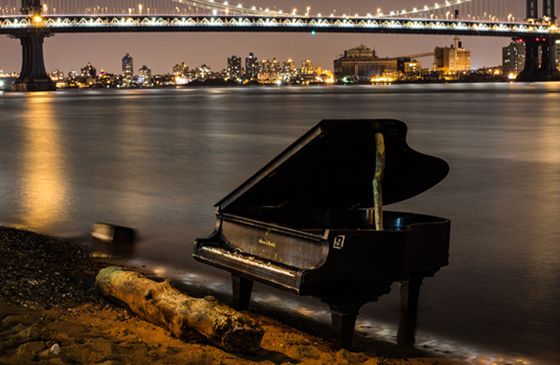 A grand piano on the banks of NYC's East River