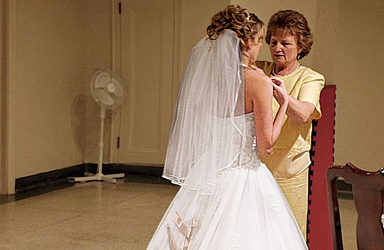 Lois helps a bride with the final adjustments to her wedding gown.