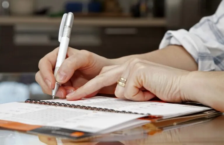 woman writing in her personal calendar