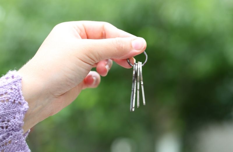 Close-up of woman holding keys.