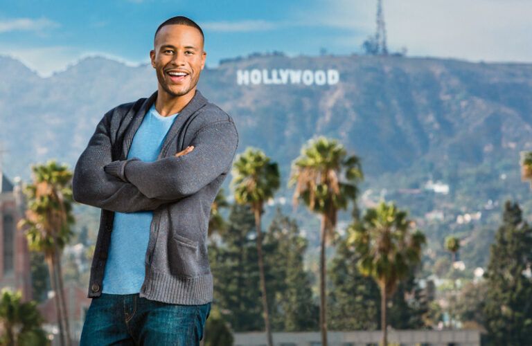 DeVon Franklin poses with the landmark Hollywood sign behind him.