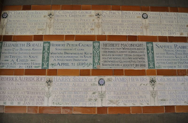 Wall of memorial plaques at Postman's Park in London.