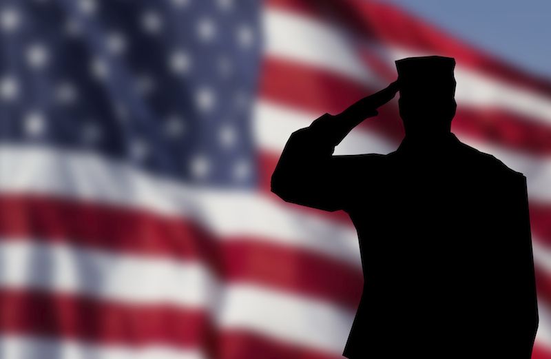 Soldier saluting the flag.