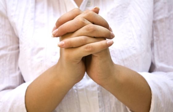 hands clasped in prayer