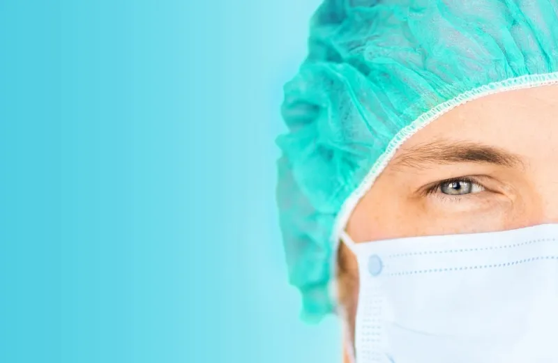 Close-up of a surgeon in scrubs.