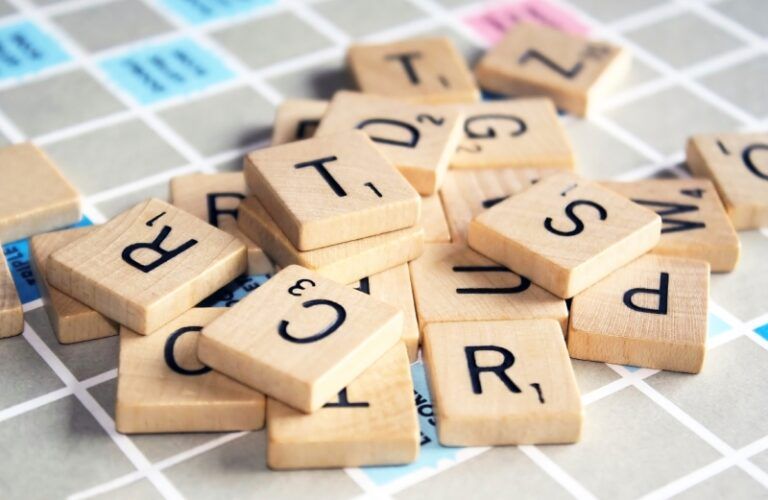 Close-up of Scrabble letter tiles jumbled on the Scrabble board.