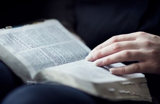 How We Got the Bible: close-up of person reading Scripture