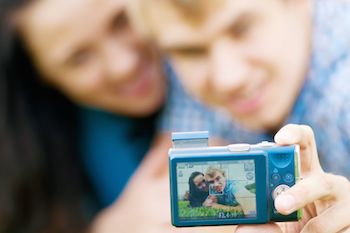 Young couple with cell phone. Photo from 123RF(r)