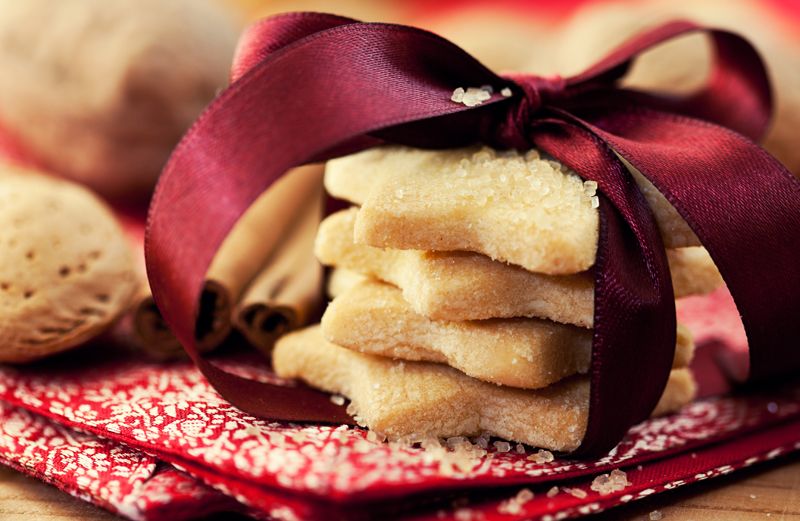 A stack of star-shaped sugar cookies with a Christmas ribbon tied around them