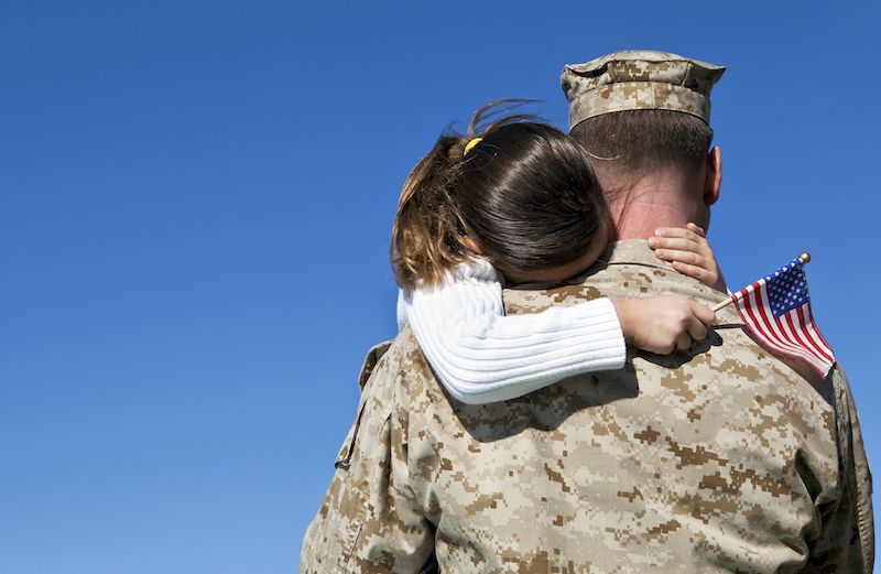 A soldier hugs his daughter. Photo by videodet for Thinkstock, Getty Images.