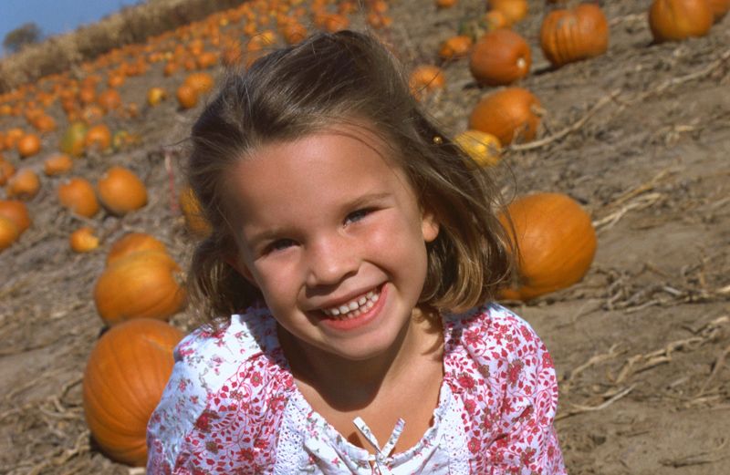girl in pumpkin patch