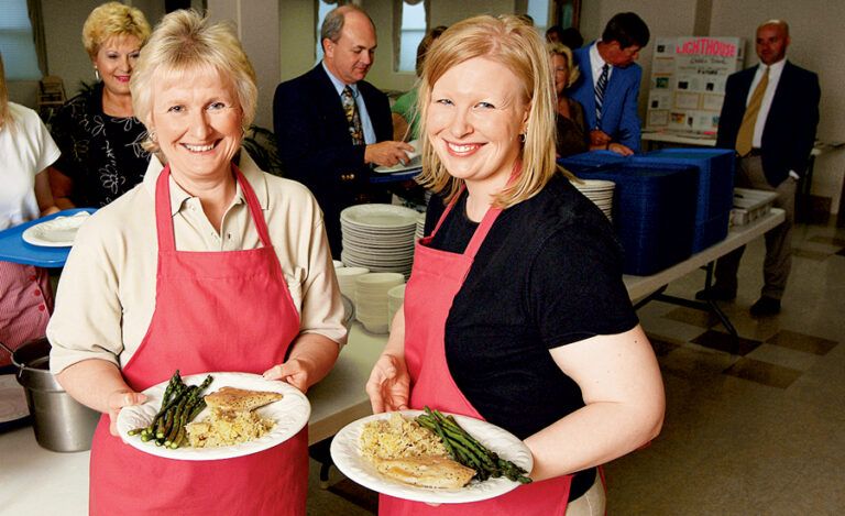 Jackie and Diane in aprons at a healthy church supper