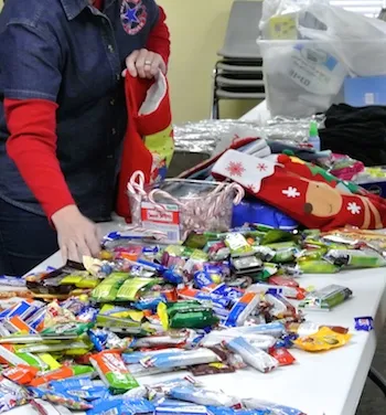 Packing Christmas presents for soldiers is underway at a Blue Star Mothers chapter.