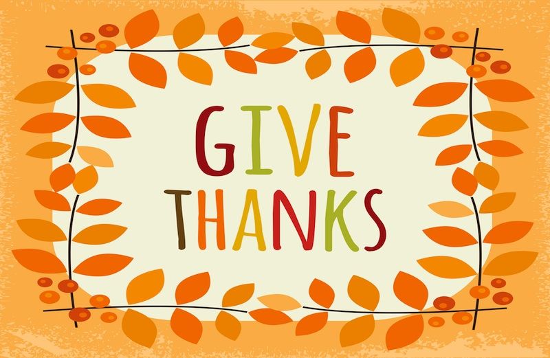 The words give thanks in colorful letters with orange leaves around it