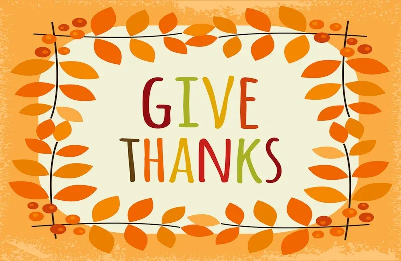 The words give thanks in colorful letters with orange leaves around it