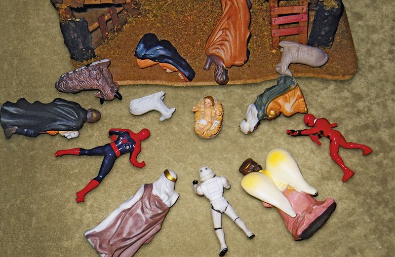 Super hero figurines bow before the Christ child.