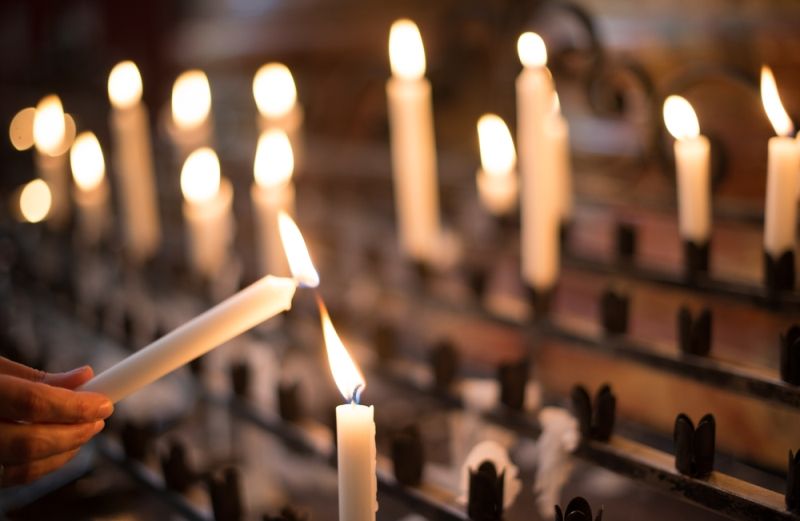 Lighting a candle in church as a gesture of thanksgiving
