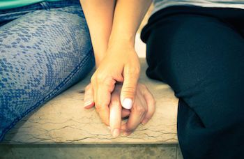 Teen girls holding hands.