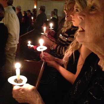 Michelle and her family at a candle light Christmas service.