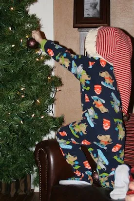 Shawnelle's son Zay helps decorate the Christmas tree.