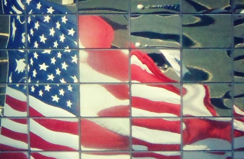 Flag reflected in mirrored building. Photo by Edie Melson.