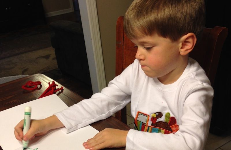 Cameron writes out his Christmas cards.